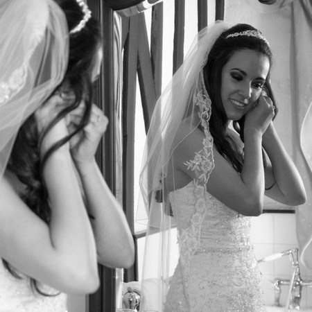 Bride putting earrings on prior to the ceremony